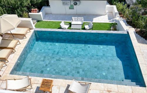 an overhead view of a swimming pool with chaise lounge chairs and a swimming pool at Gorgeous Home In Pisak With Wifi in Pisak