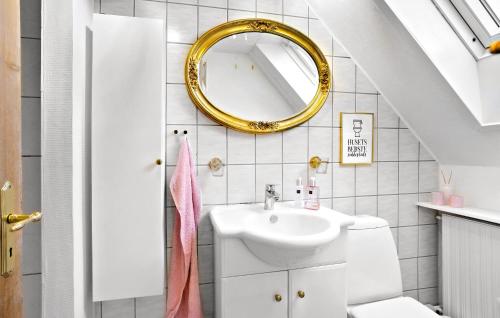 a bathroom with a sink and a mirror at 1 Bedroom Awesome Home In Middelfart in Middelfart