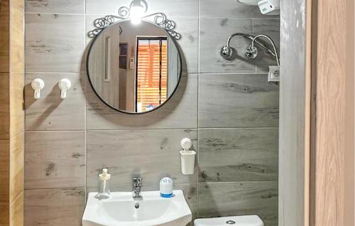 a bathroom with a sink and a mirror at Awesome Home In Lubniewice With Kitchen in Lubniewice