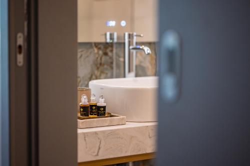 a bathroom counter with a sink and a white sink at Hotel Azur Premium in Siófok