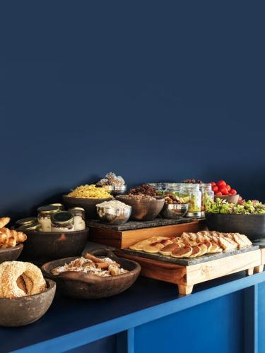 a table filled with lots of different types of food at The Newel Acropolis in Athens