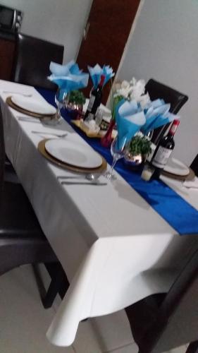 a table with plates and glasses on top of it at Reitumetse GuestHouse in Maseru