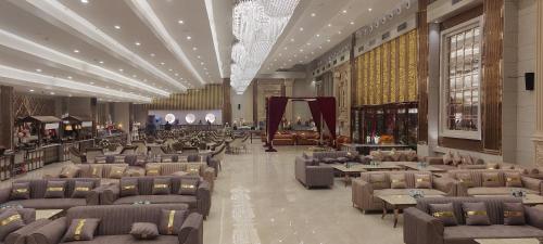 a lobby with couches and tables in a building at SK Premium Park, World Square Mall in Ghaziabad