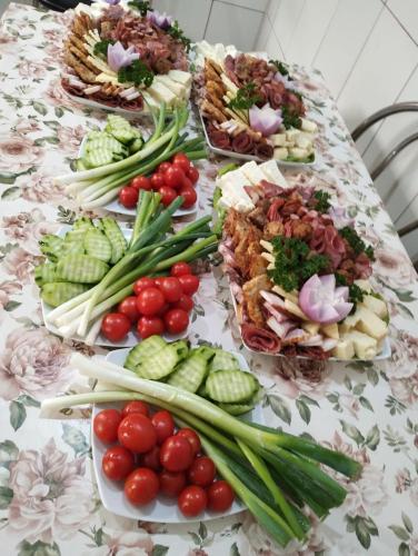 a table with many different types of food on it at Pensiunea IULIA in Rod