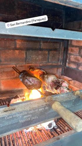 a grill with a bunch of food on fire at Casa quinta en San Bernardino in San Bernardino