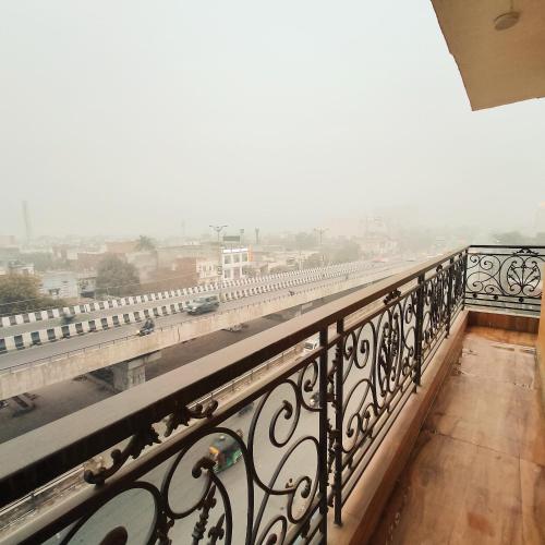 a balcony with a view of a city at Hotel East Wood Amritsar in Amritsar