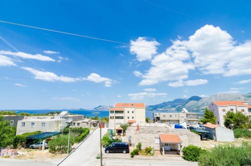 a view of a town with mountains in the background at Guesthouse Somnium in Cavtat