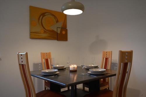 a dining room table with a candle and a painting at Ferienwohnung in Kronstorf in Kronstorf