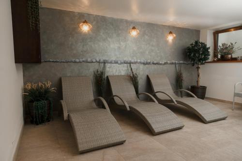 a group of chairs and plants in a room at Pušynė in Birštonas