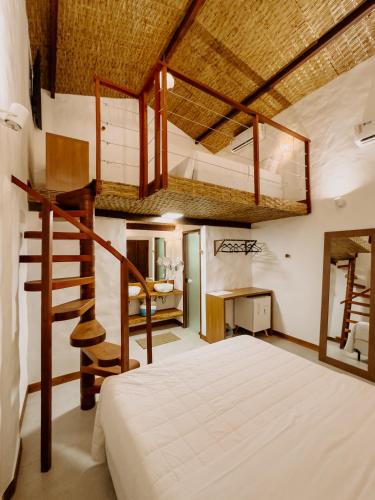 a bedroom with a bunk bed and a staircase at Pousada Vila de Pedras Noronha in Fernando de Noronha