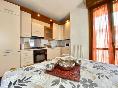 a kitchen with a table with two bowls on it at Nel Cuore della Natura - Parcheggio gratuito - Wi-Fi in Mezzolara