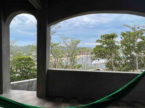 a hammock in a room with a view at Lees' Beach House in Garita