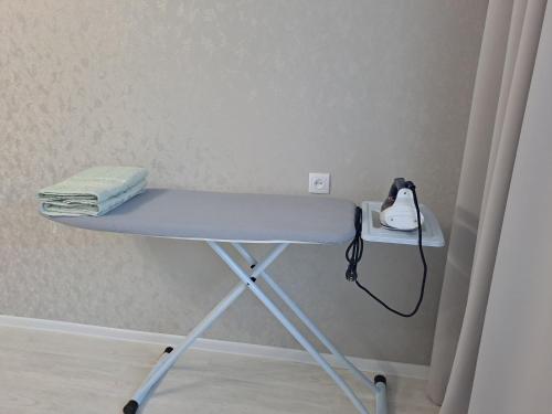 a table with a phone on top of it at Aizhan Bekshenova in Lenīnogorsk