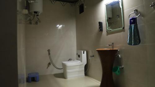 a bathroom with a toilet and a shower with a mirror at Elefantastic in Jaipur