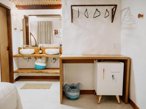 a bathroom with a sink and a mirror at Pousada Vila de Pedras Noronha in Fernando de Noronha