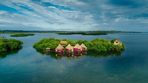 an island with houses on it in the water at Urraca Private Island Bocas del Toro in Buena Vista