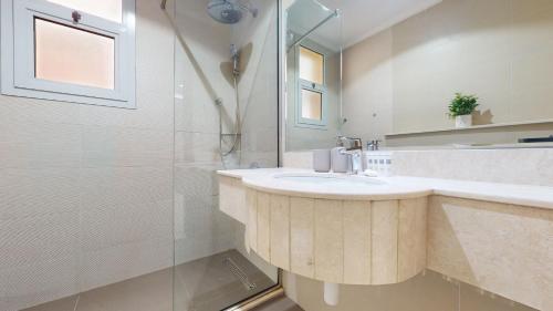 a bathroom with a sink and a shower at Primestay - VILLA 4 - JVC in Dubai