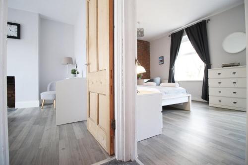 a bedroom with a bed and a dresser at Parking | 2BR | Luxurious in Cardiff