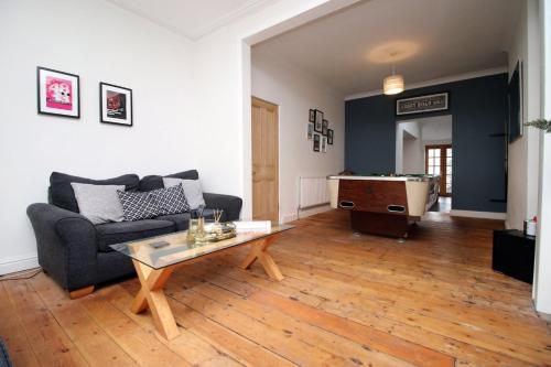 a living room with a couch and a pool table at Parking | 2BR | Luxurious in Cardiff