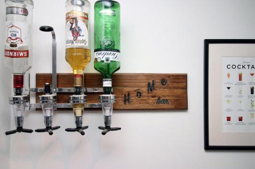 a wall mounted beer bottle rack with four beer bottles at Parking | 2BR | Luxurious in Cardiff