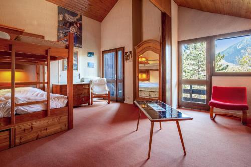 a bedroom with a bunk bed and a glass table at Chalet de 6 chambres avec vue sur la ville balcon et wifi a Briancon a 1 km des pistes in Briançon