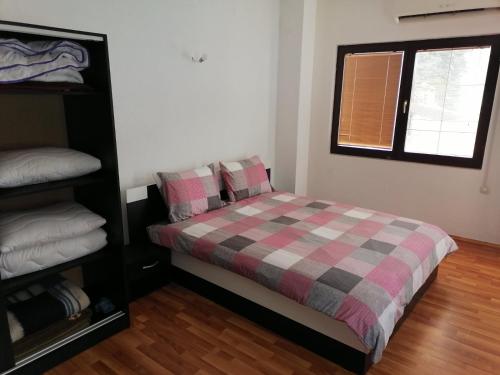a bedroom with a bed with a checkered blanket at Apartment's DAMJAN - Kruševo in Kruševo