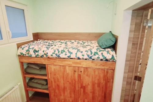 a bedroom with a bed on top of a wooden cabinet at Magnolia Green Garden New and fully equipped in Brussels