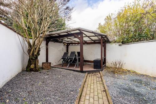 a pavilion with a table and chairs on a patio at Magnolia Green Garden New and fully equipped in Brussels