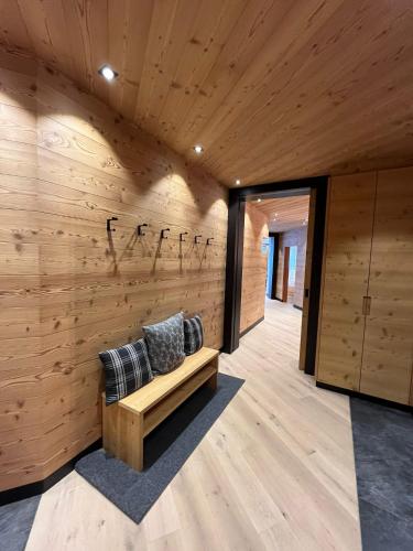 a wooden wall with a bench and a sign on it at Chalet Residence Alpinflair in Ortisei