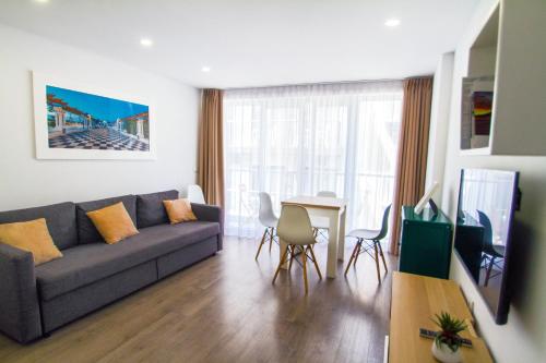 a living room with a couch and a table at Apartamentos Estemar in Benidorm