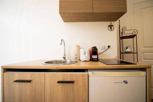 une petite cuisine avec un évier et un comptoir dans l'établissement Studio 2 personnes proche Gare du Nord, à Paris