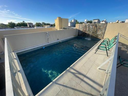 a swimming pool on the roof of a house at Gran Tuyu in San Clemente del Tuyú