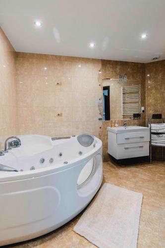 a large bathroom with a tub and a sink at Willa Łysa Góra Limanowa in Limanowa