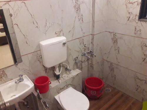 a bathroom with a toilet and a sink at HOTEL SAI MEERA PALACE in Shirdi