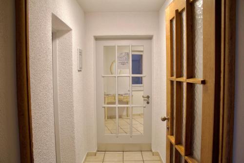 a hallway with a white door and a window at Apartments zum Bühlhof (Julie) in Zürich