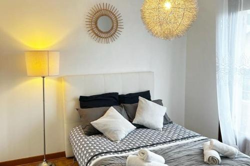 - une chambre avec un lit doté d'oreillers et d'un miroir dans l'établissement Maison Confort Stationnement Privatif 6 pers, à Échirolles