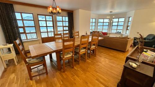 a dining room and living room with a table and chairs at Guesthouse at Dynjandi Falls in Bíldudalur