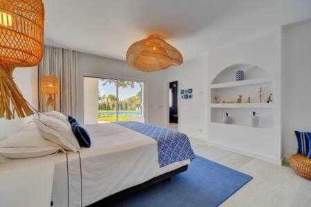 een slaapkamer met een groot bed en een blauw tapijt bij Luxuosa Villa Miramar Carvoeiro in Carvoeiro
