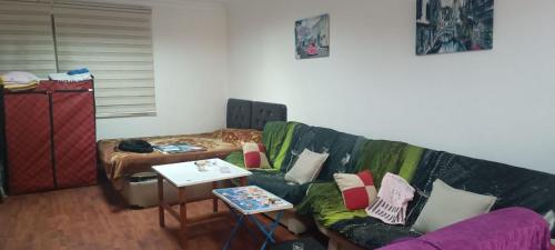 a living room with a couch and a table at ROOMS AND APARTMENTS center of Antalya, beach, old town in Antalya