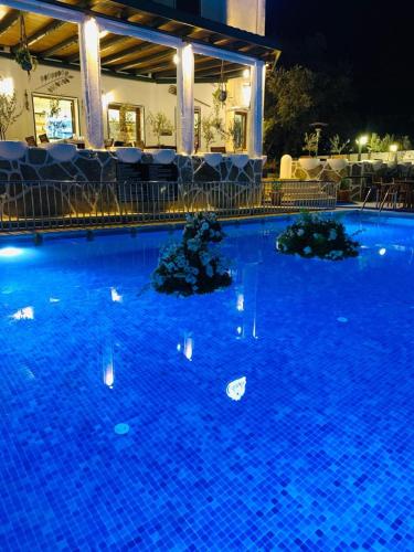a large blue swimming pool at night at Eden Hotel in Bodrum City