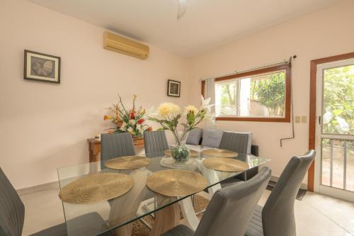 a dining room with a glass table and chairs at Dawn Beach Estate - 3 bedroom Apartment Villa villa in Dawn Beach