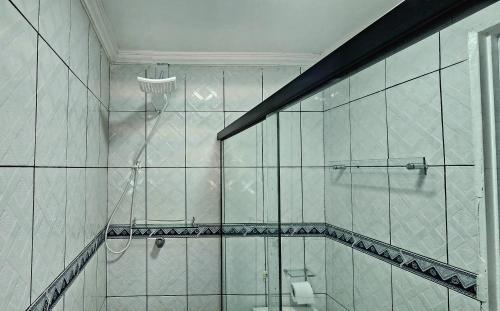 a bathroom with a glass shower with a toilet at Apart Hotel Farol de Itapuã - Suíte com cozinha completa à 250m da praia e farol de Itapuã in Salvador