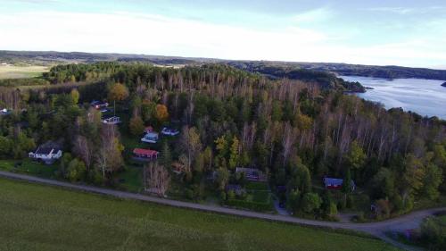 an aerial view of a house in a forest next to a river at Bergsviksvägen 5, Munkedal in Munkedal