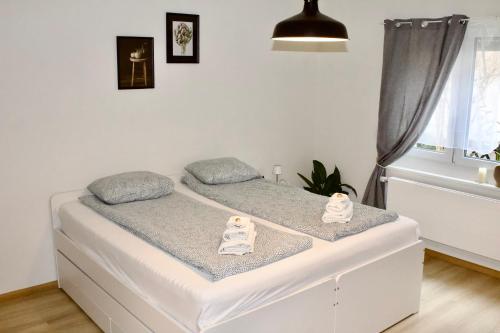 a bed in a small room with towels on it at Apartments zum Bühlhof (Alfred) in Zurich
