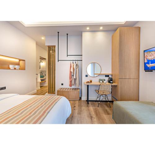 a bedroom with a bed and a desk in a room at Oniro Suites in Rethymno Town