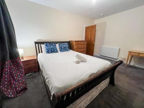 a bedroom with a large bed with blue pillows at Charming 2Bed Apartment in the Heart of Edinburgh in Edinburgh