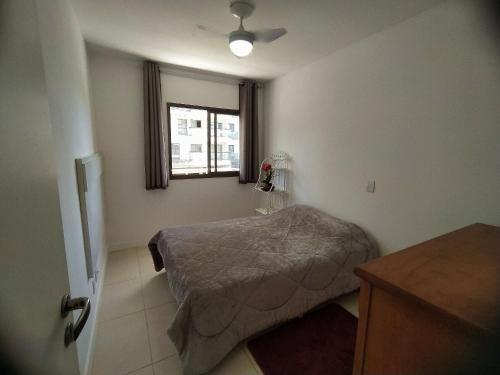 a small bedroom with a bed and a window at Rio Marina Resort in Mangaratiba