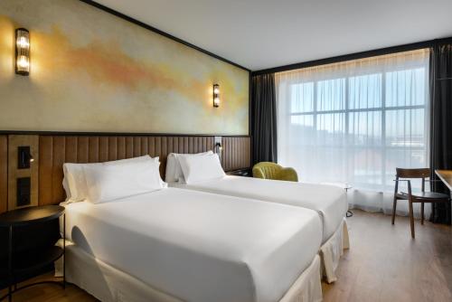 a hotel room with two beds and a window at Barceló Warsaw Powiśle in Warsaw