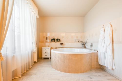 Mostkovice的住宿－Hotel Plumlov，带浴缸和淋浴帘的浴室