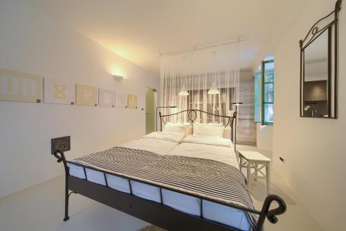 a bedroom with a bed in a white room at BASTINICA KRK Studio Ap 2, OldTown, CityCenter in Krk